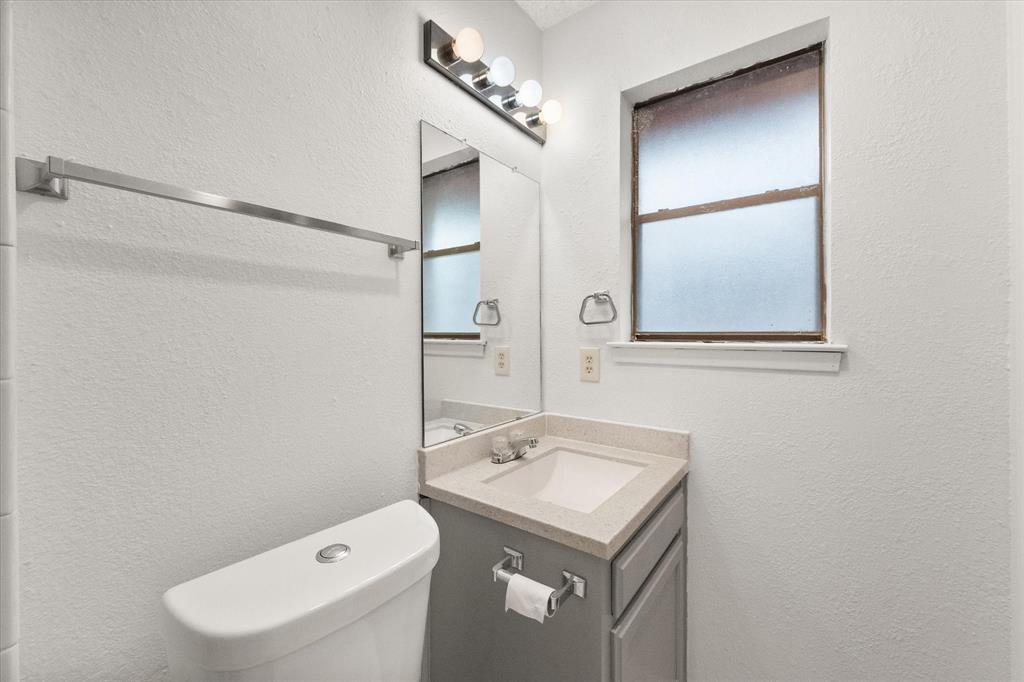 2305 Gilbert Circle Arlington, TX 76010 - Photo 23 of 38 a bathroom with a sink toilet and mirror