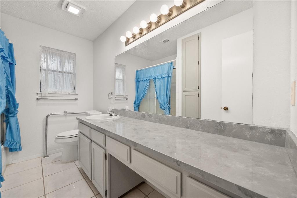 2305 Gilbert Circle Arlington, TX 76010 - Photo 24 of 38 a bathroom with a sink and a mirror