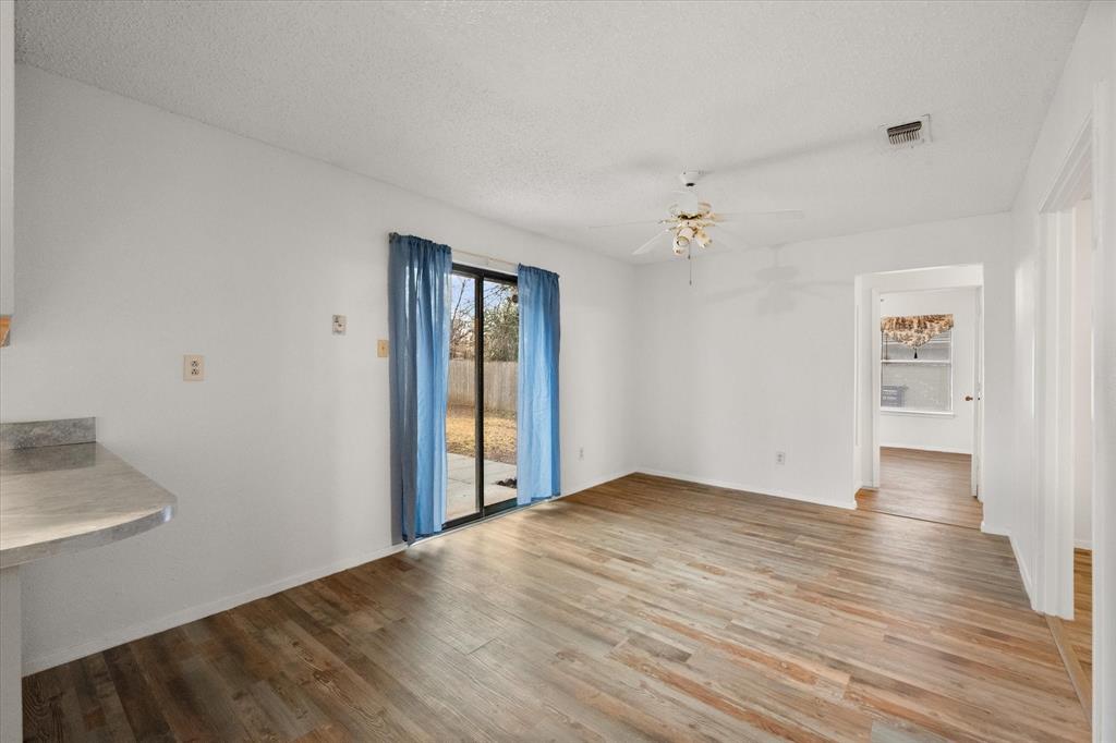 2305 Gilbert Circle Arlington, TX 76010 - Photo 28 of 38 wooden floor in an empty room with a window