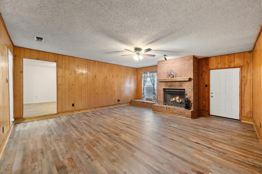 2305 Gilbert Circle Arlington, TX 76010 - Photo 31 of 38 a view of empty room with wooden floor and fireplace
