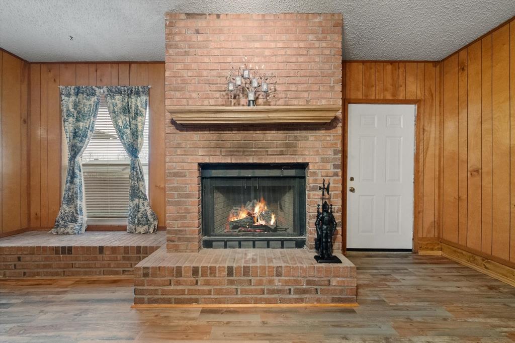 2305 Gilbert Circle Arlington, TX 76010 - Photo 32 of 38 a living room with furniture and a fireplace