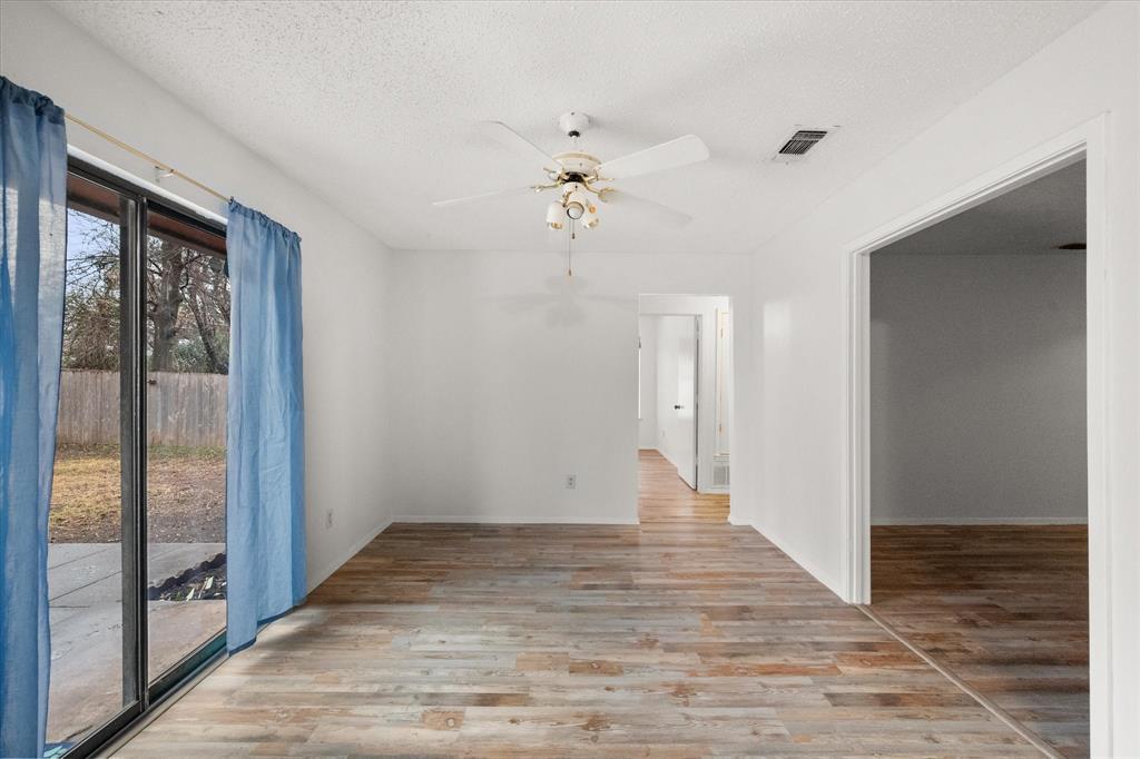 2305 Gilbert Circle Arlington, TX 76010 - Photo 37 of 38 a view of an empty room with wooden floor and a window