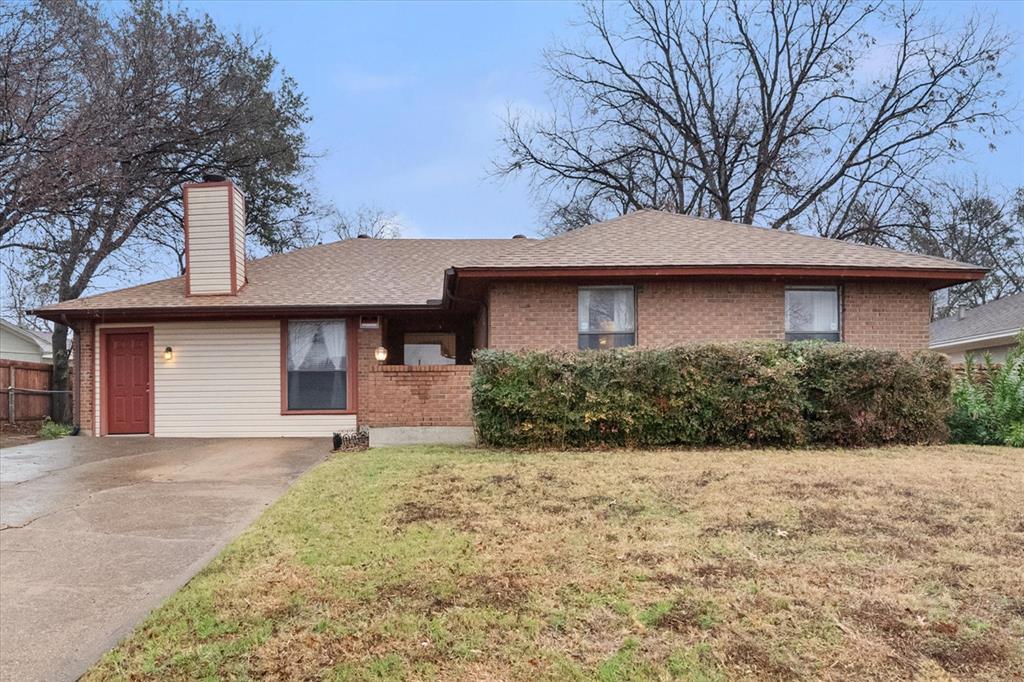2305 Gilbert Circle Arlington, TX 76010 - Photo 38 of 38 a front view of a house with a yard and garage