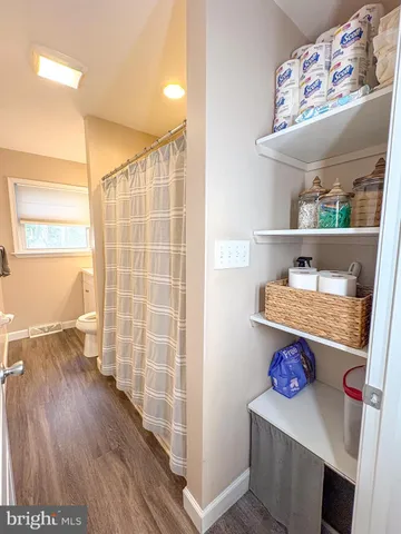a view of room with window and wooden floor