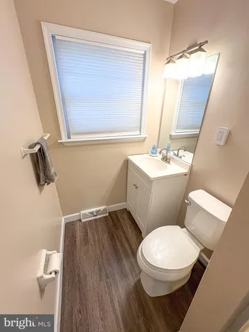 a white toilet sitting next to a bathroom sink