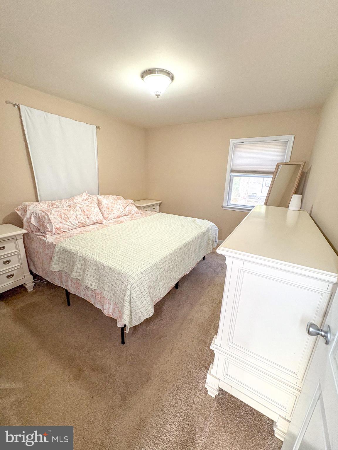 3705 Firetower Road Felton, DE 19943 - Photo 32 of 40 a bed sitting in a bedroom next to a window
