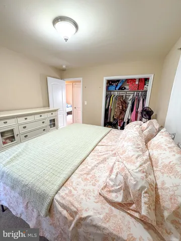 a bedroom with a bed and a night stand