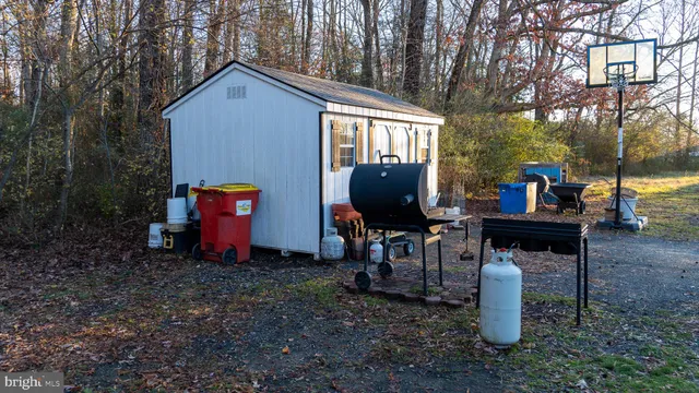 a front view of a house with garden and chairs