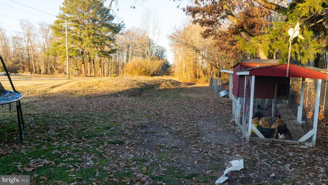 a backyard of a house with barbeque oven and outdoor seating
