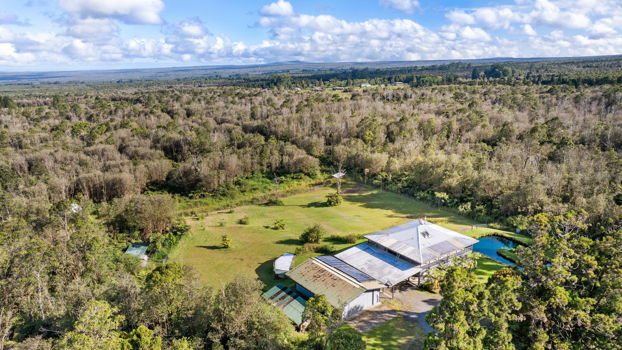 18-4565 Makaala Rd Mountain View Mountain View, HI 96771 - Photo 24 of 25 a view of a yard with swimming pool in front of house