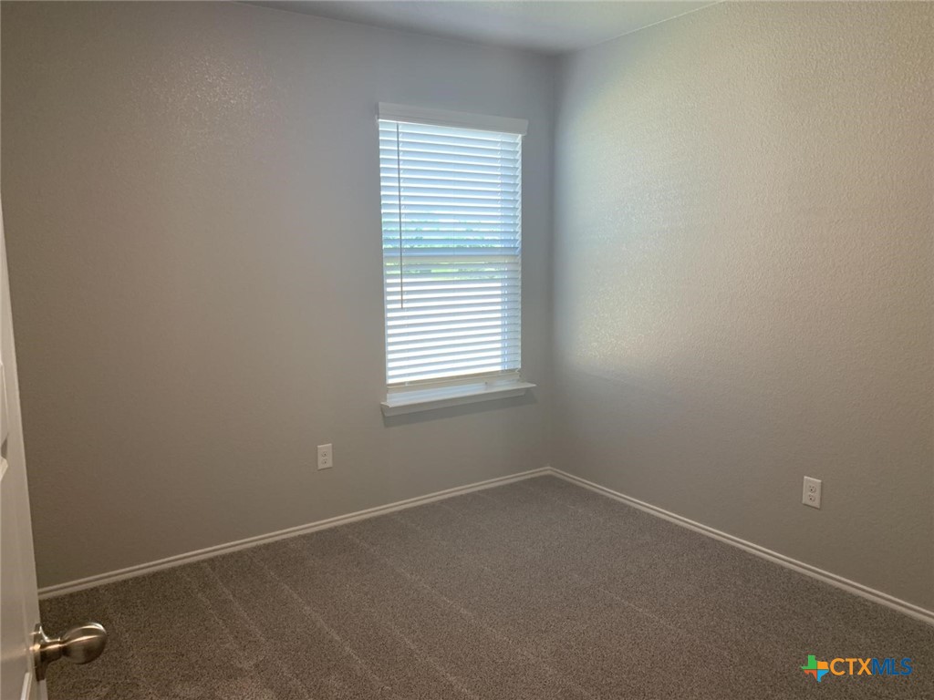 716 Kimble Drive, Unit B Temple, TX 76501 - Photo 12 of 23 an empty room with a window
