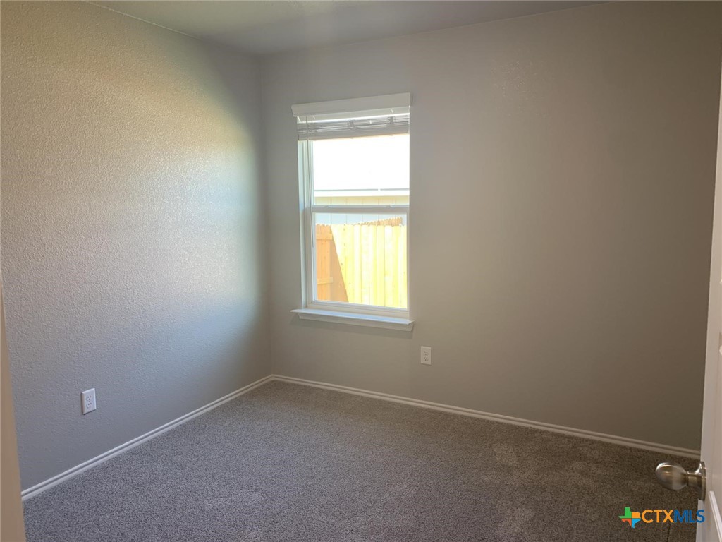 716 Kimble Drive, Unit B Temple, TX 76501 - Photo 13 of 23 an empty room with a window