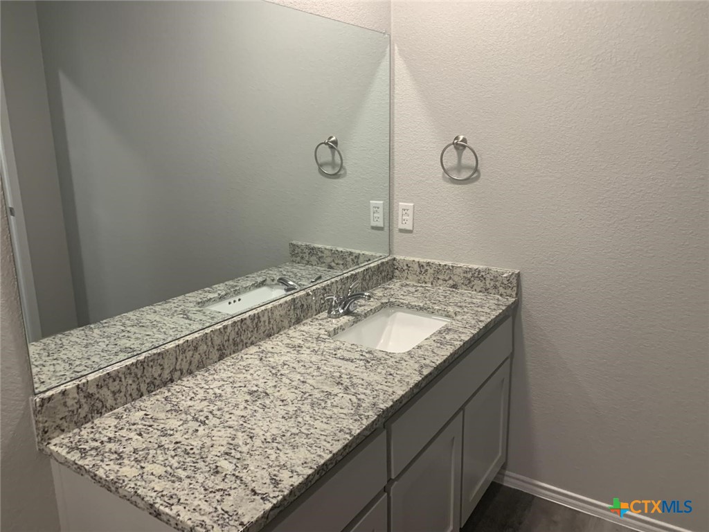 716 Kimble Drive, Unit B Temple, TX 76501 - Photo 16 of 23 a bathroom with a granite countertop sink and vanity