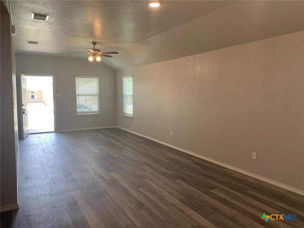 716 Kimble Drive, Unit B Temple, TX 76501 - Photo 2 of 23 an empty room with wooden floor and windows