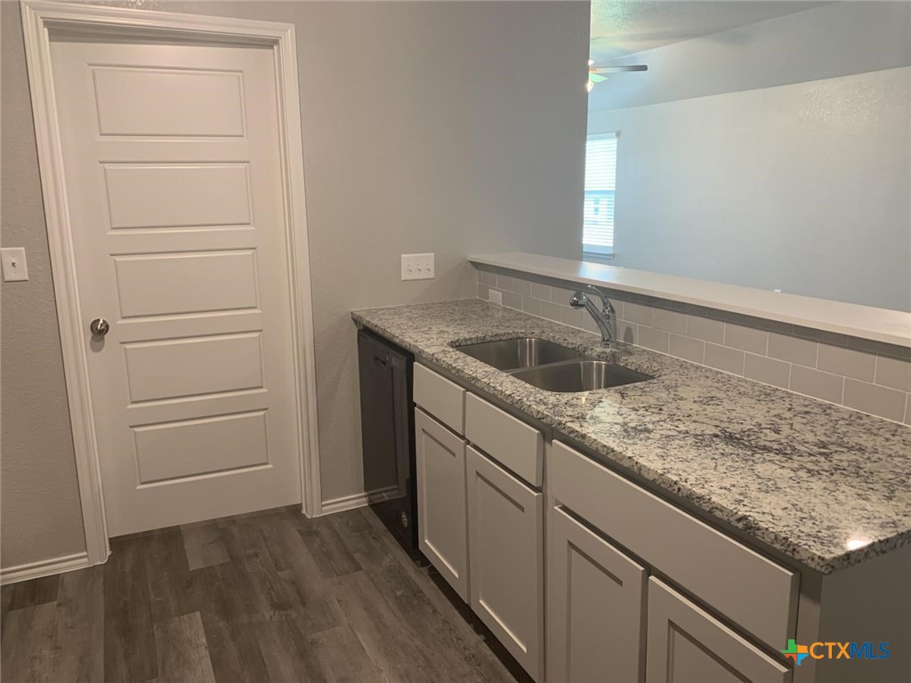 716 Kimble Drive, Unit B Temple, TX 76501 - Photo 21 of 23 a kitchen with a sink and cabinets