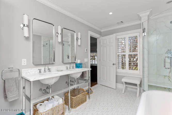 3 Owenoke Way Riverside, CT 06878 - Photo 17 of 33 a spacious bathroom with a double vanity sink a mirror and a bathtub