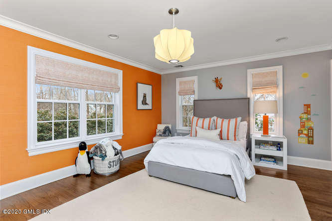 3 Owenoke Way Riverside, CT 06878 - Photo 19 of 33 a bedroom with bed and a large window