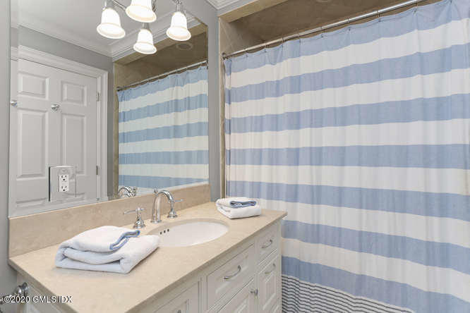 3 Owenoke Way Riverside, CT 06878 - Photo 23 of 33 a bathroom with a sink a large mirror and a shower