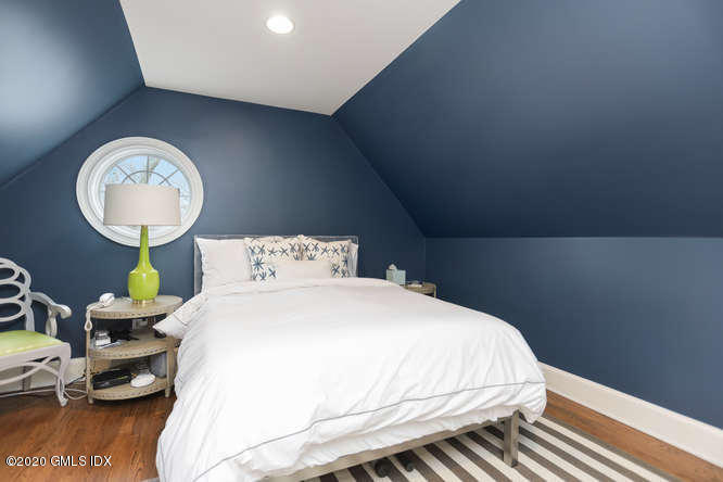 3 Owenoke Way Riverside, CT 06878 - Photo 24 of 33 a bedroom with a bed and a potted plant