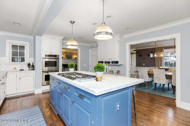 3 Owenoke Way Riverside, CT 06878 - Photo 5 of 33 a open kitchen with a stove a sink dishwasher a dining table and chairs with wooden floor