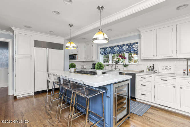 3 Owenoke Way Riverside, CT 06878 - Photo 6 of 33 a kitchen with a stove a window and wooden cabinets