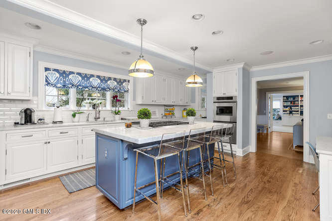 3 Owenoke Way Riverside, CT 06878 - Photo 8 of 33 a kitchen with a sink counter and chairs