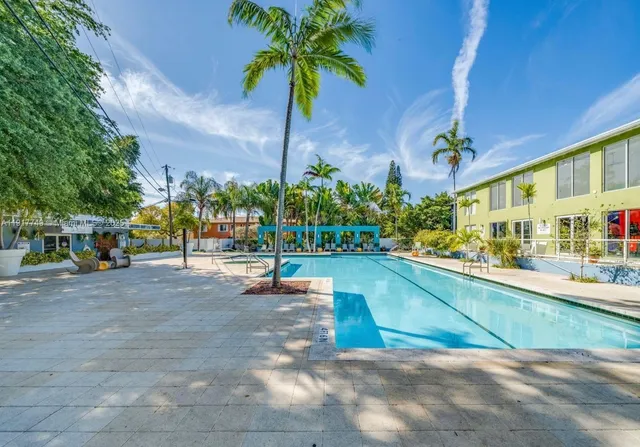 a view of a swimming pool with an outdoor space and seating area
