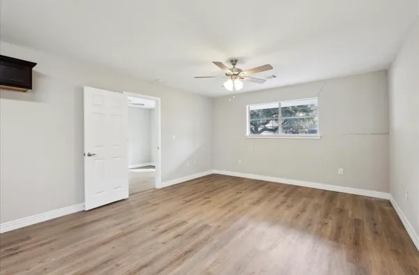 wooden floor in an empty room with a window