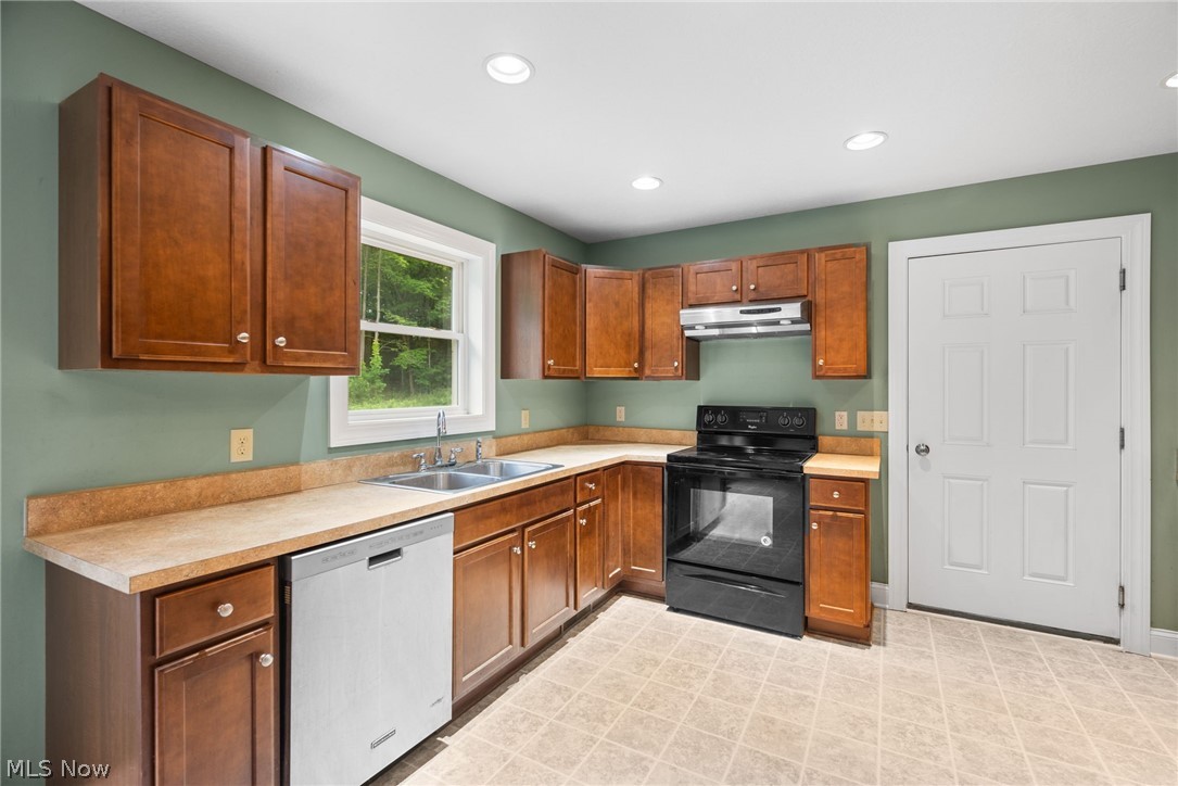 16985 Moseley Road Thompson, OH 44086 - Photo 4 of 22 Kitchen featuring light tile floors, sink, stainless steel dishwasher, and black electric range