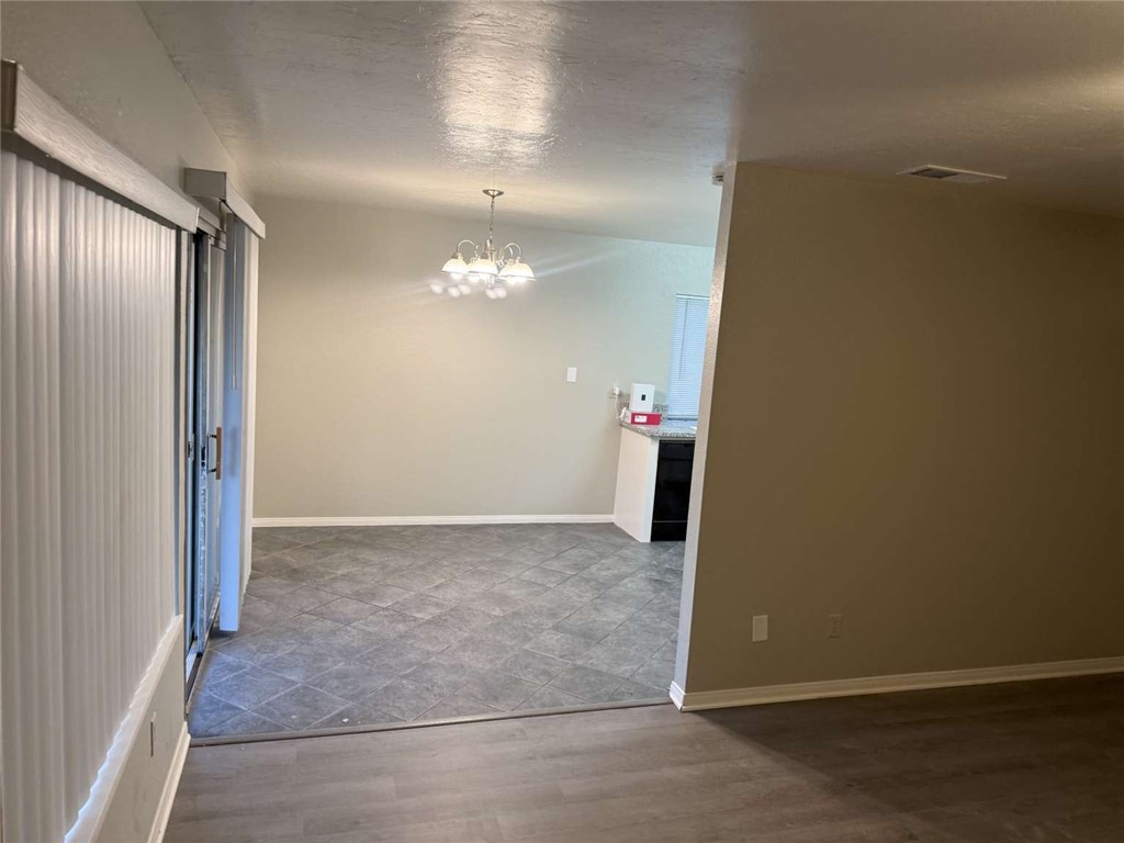 3270 Edgemont Court San Bernardino, CA 92405 - Photo 11 of 44 an empty room with staircase and mirror