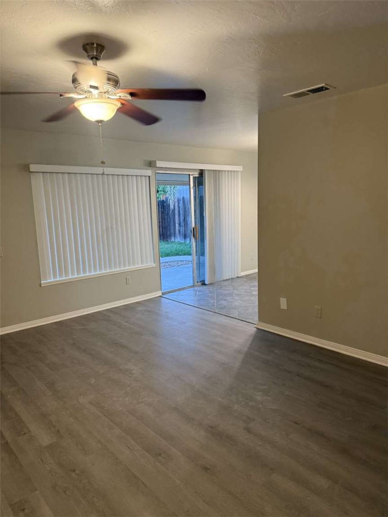 3270 Edgemont Court San Bernardino, CA 92405 - Photo 13 of 44 a view of an empty room with window and wooden floor