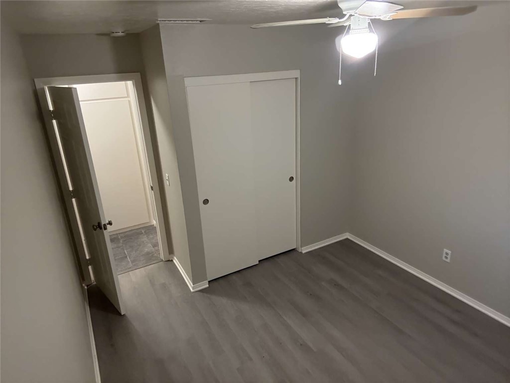 3270 Edgemont Court San Bernardino, CA 92405 - Photo 15 of 44 an empty room with wooden floor and windows