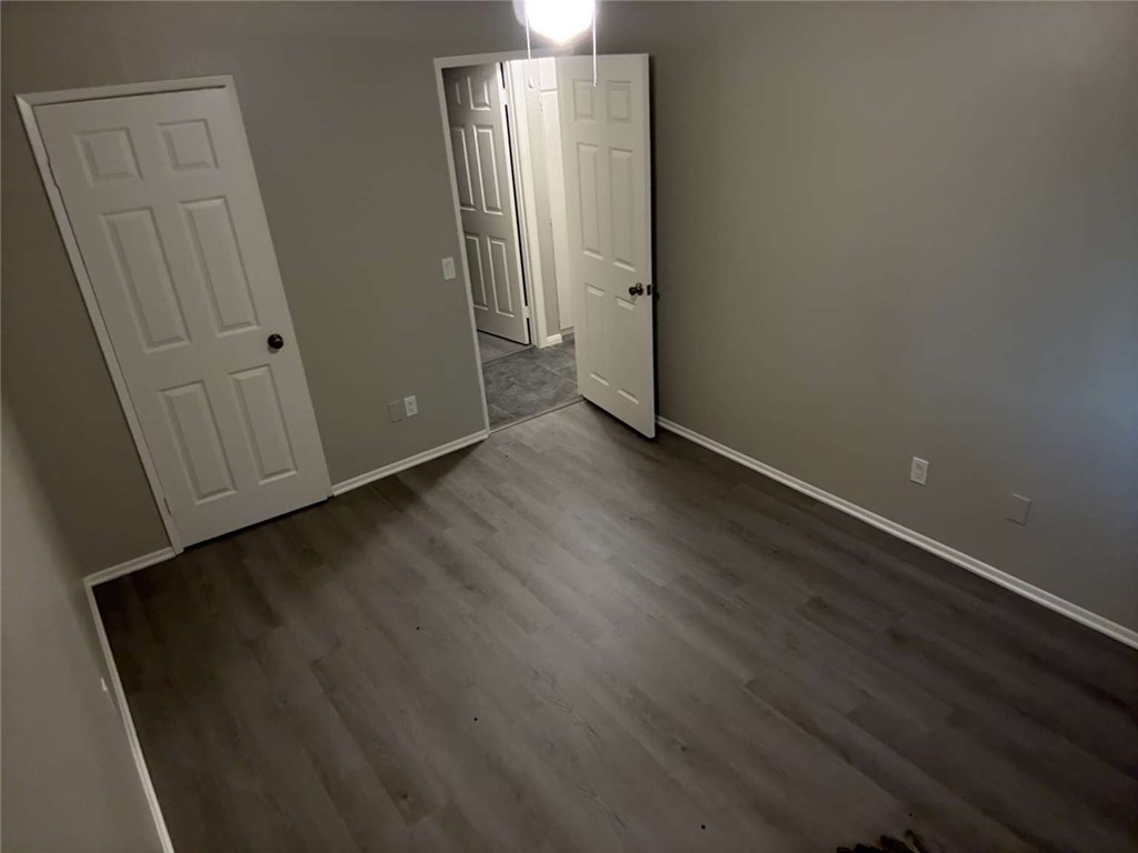 3270 Edgemont Court San Bernardino, CA 92405 - Photo 16 of 44 an empty room with wooden floor and a window