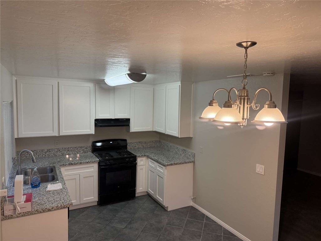 3270 Edgemont Court San Bernardino, CA 92405 - Photo 5 of 44 a kitchen that has a lot of cabinets and appliances