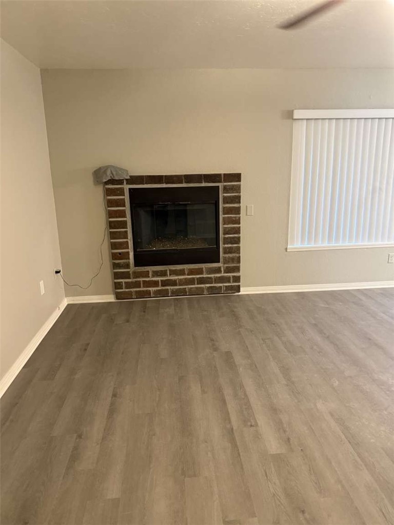 3270 Edgemont Court San Bernardino, CA 92405 - Photo 9 of 44 a view of an empty room with a fireplace and a window
