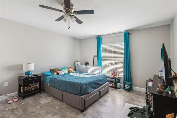 a bedroom with two beds and a desk