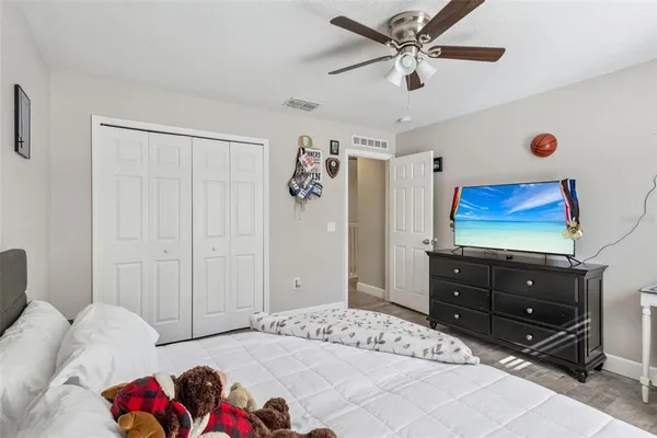 a bedroom with a bed and a couch