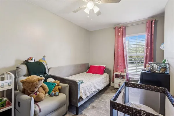 a bedroom with furniture and a wooden floor