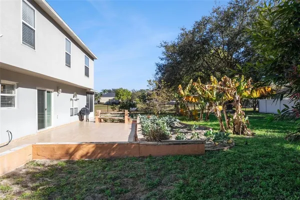 a front view of a house with a yard and potted plants