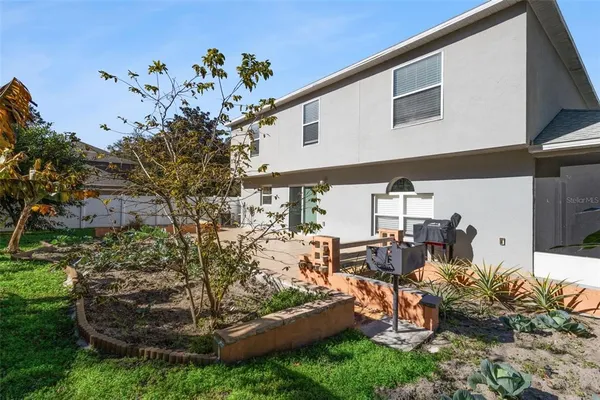 a view of a house with a big yard and potted plants