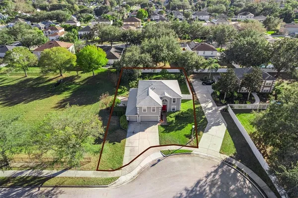 an aerial view of a house with garden space and street view