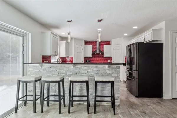 a kitchen with kitchen island granite countertop a table and chairs in it