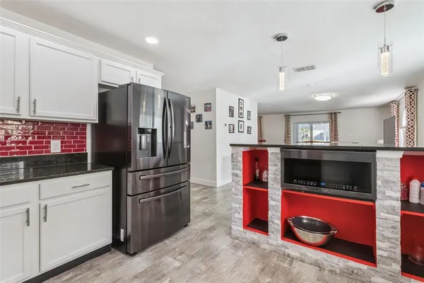 a kitchen with stainless steel appliances granite countertop a refrigerator and a sink