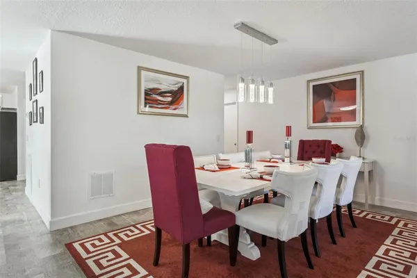 a view of a dining room with furniture and wooden floor