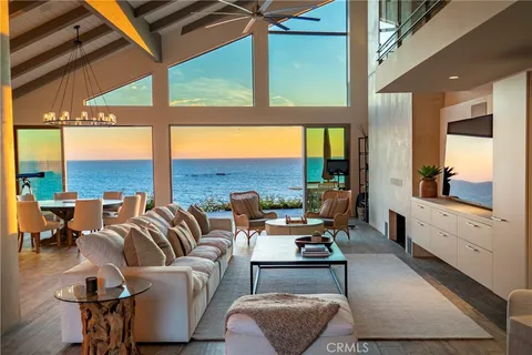 a living room with fireplace furniture and a large window