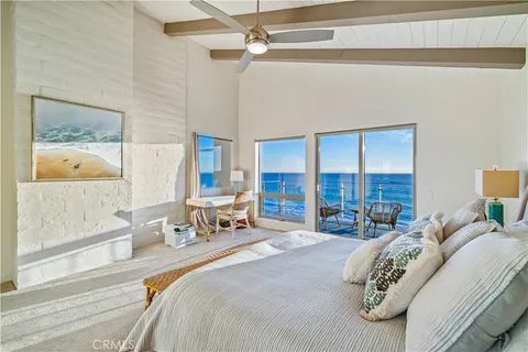 a bedroom with a bed a couch and dresser