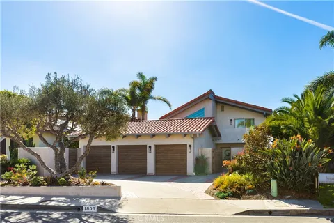 a front view of a house with a tree