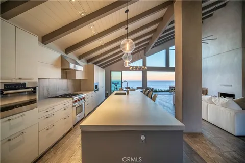 a kitchen with stainless steel appliances a sink a stove and cabinets
