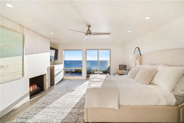 a bedroom with a bed a fireplace and a chandelier