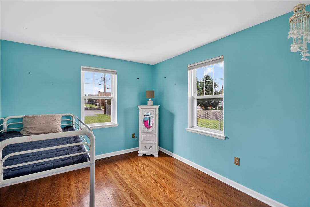 23 Harrison Street Emmaus, PA 18049 - Photo 18 of 28 Hardwood floors and generous windows characterize this well-lit secondary bedroom.